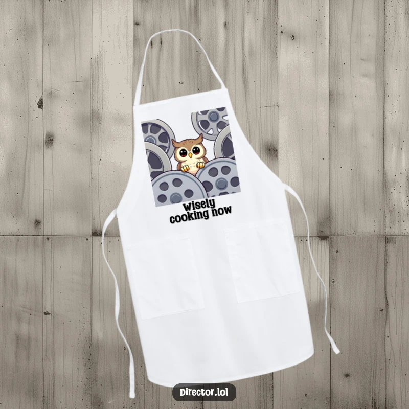 Funny Apron with a happy owl peeking curiously over film reels, perfect for chefs who enjoy movies and a bit of kitchen humor.