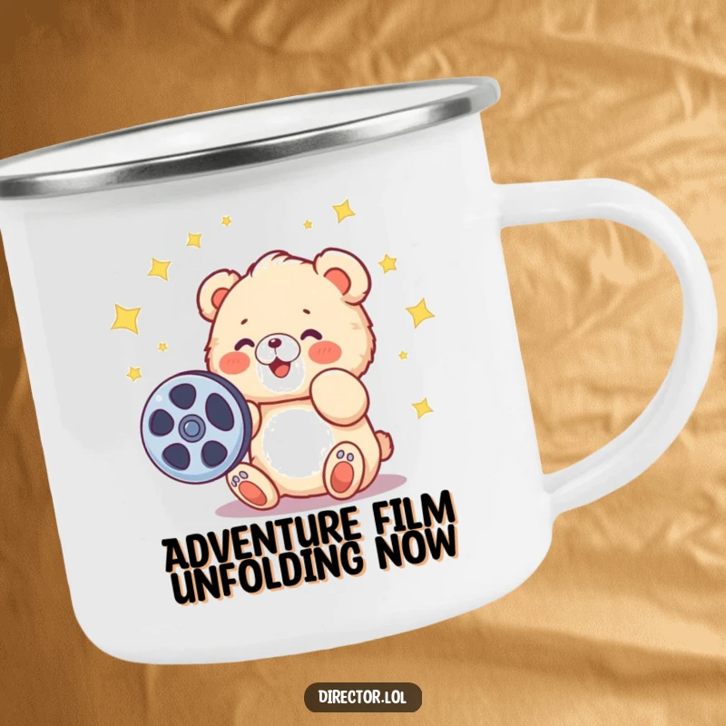 Funny camping mug featuring a fluffy cartoon bear cub spinning a film reel, stars around, ideal for outdoor storytelling.