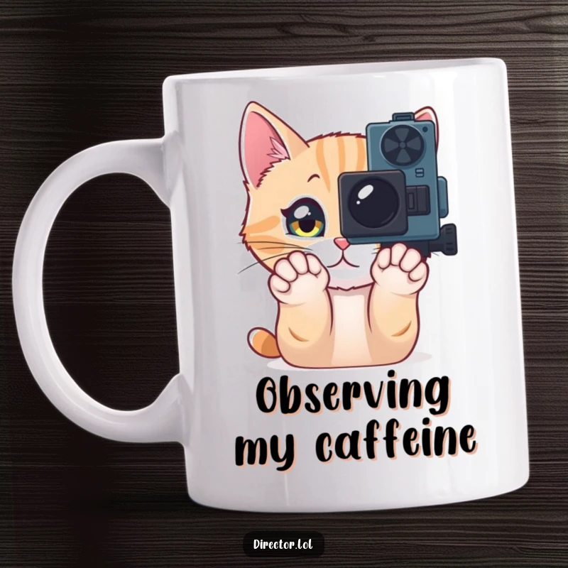Funny Mug featuring a curious cat pawing at a movie camera with wide, sparkling eyes, embodying a fascination with storytelling and humor.