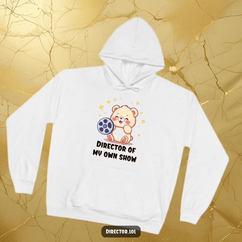 Funny hoodie featuring a fluffy cartoon bear cub spinning a film reel, stars abound, perfect for warm, creative lounging.