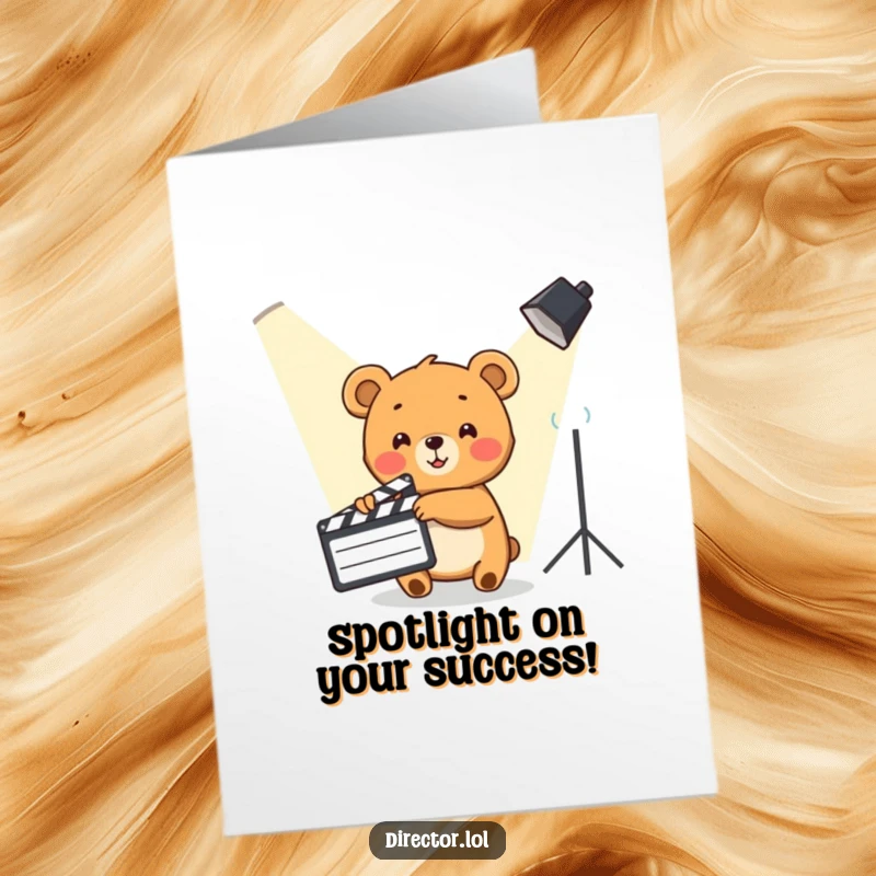 Funny Free Printable Congrats Card: Cute bear cub enthusiastically points with a clapboard towards a spotlight, congratulating success.