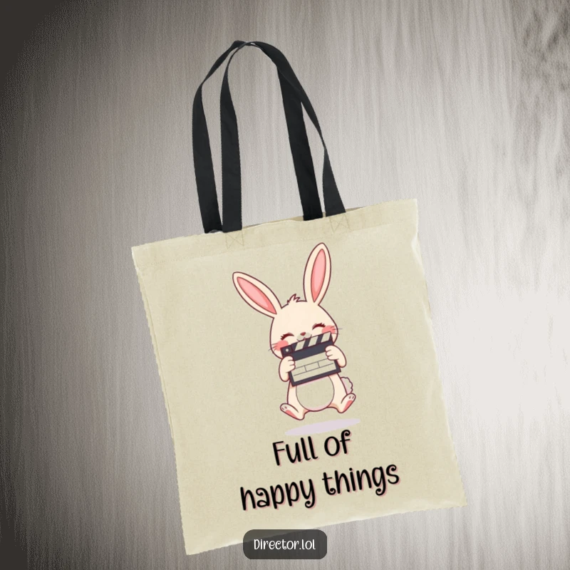 Funny tote bag depicting a giggling cartoon bunny holding a clapboard and jumping with pure cinematic excitement.