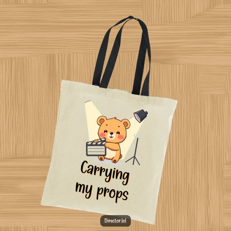 Funny Bear Cub Tote Bag: Cute bear cub enthusiastically points a clapboard towards a spotlight, a movie-themed accessory.