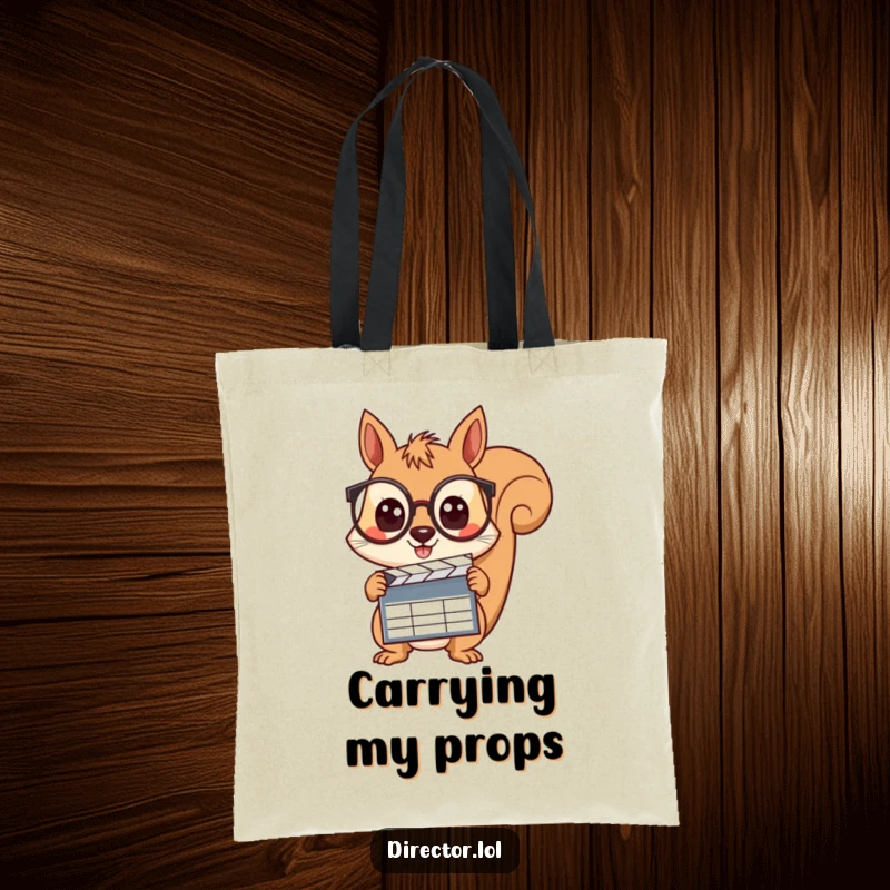 Funny squirrel wearing spectacles, holding a clapboard with wide, curious eyes, ready to film the day on this stylish tote bag.
